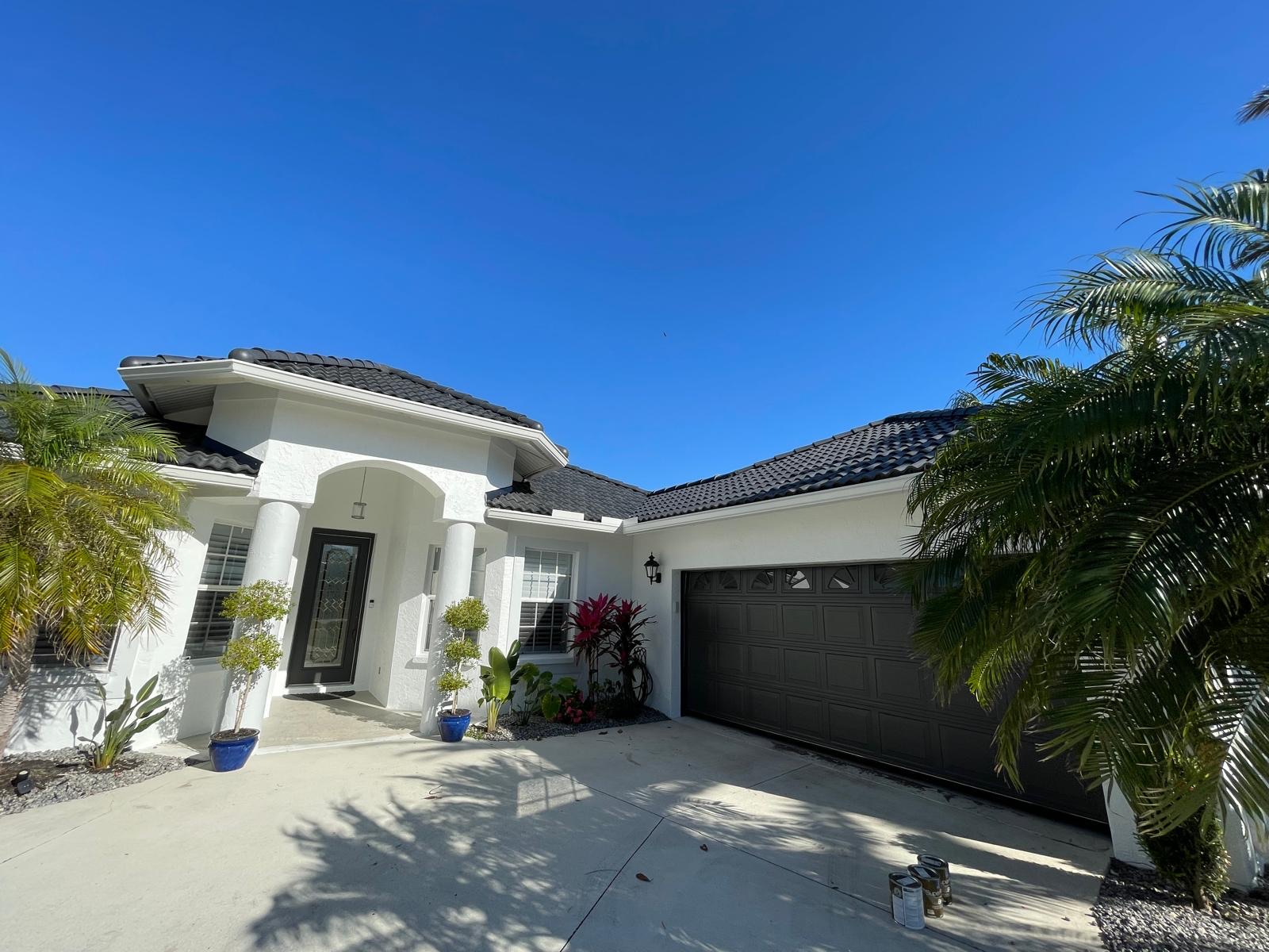 Exterior entry with freshly painted door and stucco finish